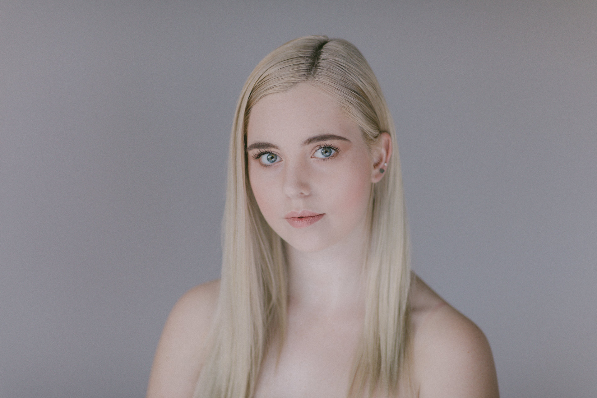 model portrait - straight looking - plain white backdrop