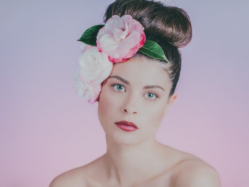beautiful girl portrait photographed by melbourne beauty photographer - pink backdrop - pink flowers - camelias